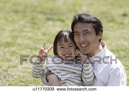 Stock Photo - Portrait of a father smiling with daughter. Fotosearch
