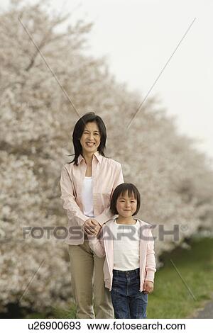 Portrait of a mother and daughter holding hands View Large Photo Image Stock Image - Portrait of a mother and daughter holding hands. Fotosearch