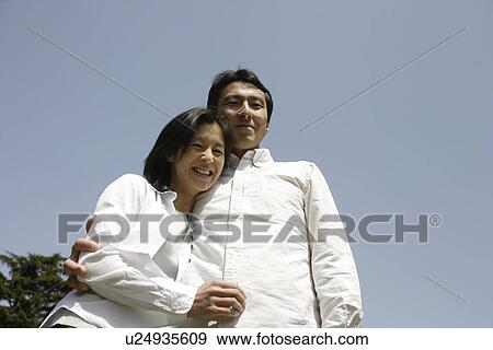 Portrait of a young couple smiling View Large Photo Image Stock Photo - Portrait of a young couple smiling. Fotosearch