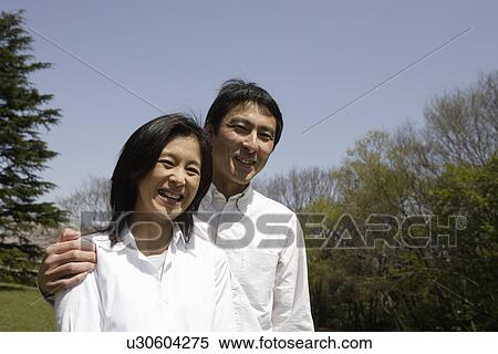 Stock Photography - Portrait of a young couple smiling. Fotosearch