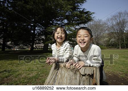 Stock Image - Portrait of brother and sister smiling. Fotosearch