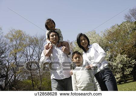 Stock Photo - Portrait of parents smiling with children. Fotosearch