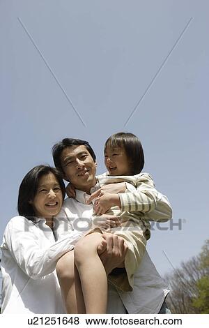 Portrait of parents smiling with daughter View Large Photo Image Stock Photo - Portrait of parents smiling with daughter. Fotosearch