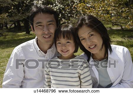 Portrait of parents smiling with daughter View Large Photo Image Stock Photograph - Portrait of parents smiling with daughter. Fotosearch