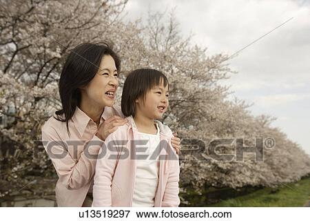 View of a mother and daughter smiling View Large Photo Image Stock Photo - View of a mother and daughter smiling. Fotosearch