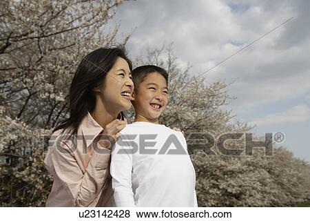 Stock Photo - View of a mother and son smiling. Fotosearch