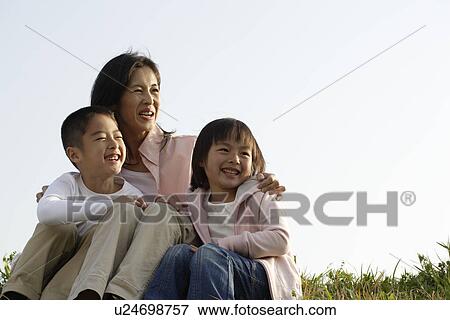 View of a mother smiling with children View Large Photo Image Stock Photo - View of a mother smiling with children. Fotosearch