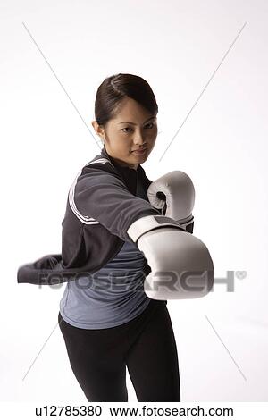 Portrait of a young woman boxing View Large Photo Image Stock Image - Portrait of a young woman boxing. Fotosearch