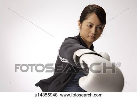 Portrait of a young woman boxing View Large Photo Image Stock Photo - Portrait of a young woman boxing. Fotosearch