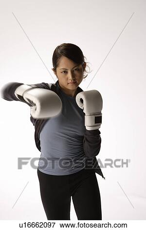 Portrait of a young woman boxing View Large Photo Image Stock Photo - Portrait of a young woman boxing. Fotosearch