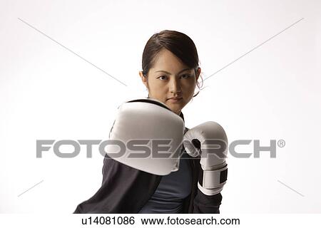 Portrait of a young woman boxing View Large Photo Image Stock Photograph - Portrait of a young woman boxing. Fotosearch