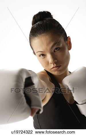Portrait of a young woman with boxing gloves View Large Photo Image Stock Image - Portrait of a young woman with boxing gloves. Fotosearch