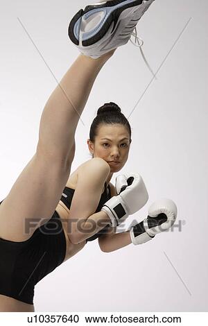View a young woman kicking View Large Photo Image Stock Image - View a young woman kicking. Fotosearch