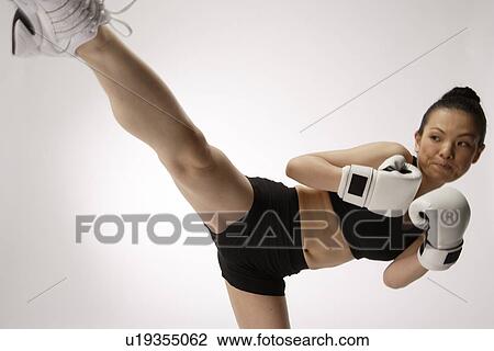 View a young woman kicking View Large Photo Image Stock Image - View a young woman kicking. Fotosearch