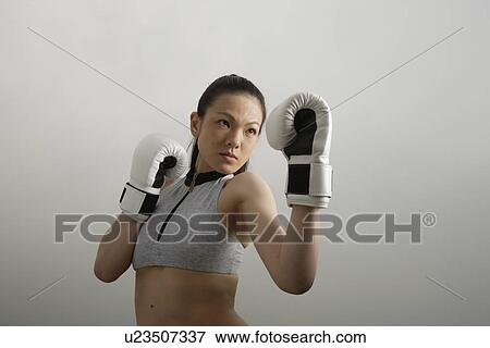 View of a young woman boxing View Large Photo Image Stock Photo - View of a young woman boxing. Fotosearch