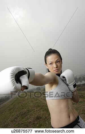 View of a young woman boxing View Large Photo Image Stock Photo - View of a young woman boxing. Fotosearch