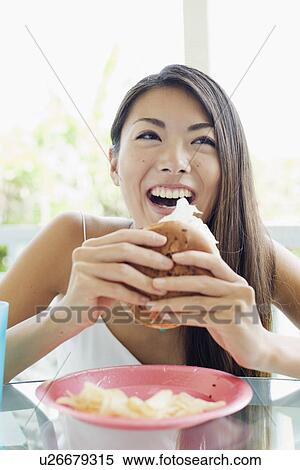 A young woman holding burger View Large Photo Image Stock Photography - A young woman holding burger. Fotosearch