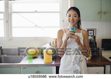 Stock Photograph - A young woman holding glass. Fotosearch