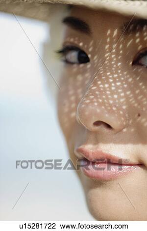 Stock Image - Portrait of a young woman smiling. Fotosearch