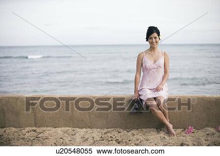 A woman sitting on wall by sea View Large Photo Image Stock Photography - A woman sitting on wall by sea. Fotosearch