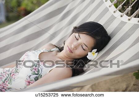A woman sleeping on hammock View Large Photo Image Stock Photography - A woman sleeping on hammock. Fotosearch