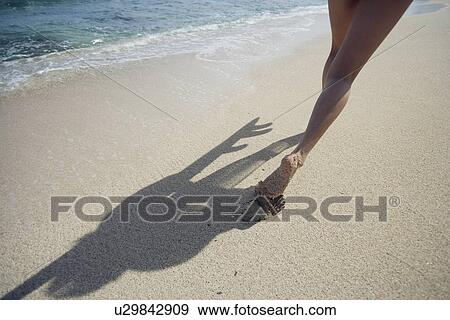 A woman strolling on beach View Large Photo Image Stock Photo - A woman strolling on beach. Fotosearch