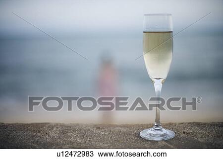 Stock Image - Close-up of wineglass filled with alcoholic beverage. Fotosearch