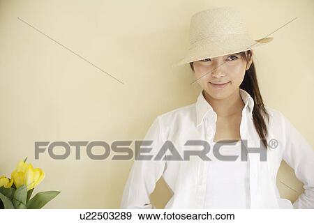 Stock Photo - A young woman wearing hat. Fotosearch