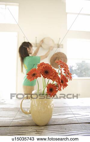 Woman with flowerpot in foreground View Large Photo Image Stock Image - Woman with flowerpot in foreground. Fotosearch