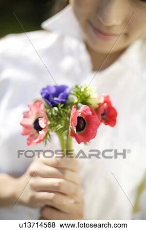 Stock Photo - Woman with flowers in foreground. Fotosearch