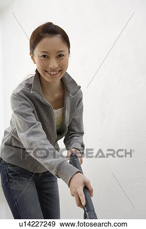 Portrait of a cheerful young woman working View Large Photo Image Stock Photo - Portrait of a cheerful young woman working. Fotosearch