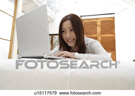 A young woman using laptop View Large Photo Image Stock Photo - A young woman using laptop. Fotosearch