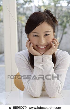 Stock Photo - Portrait of a young woman smiling. Fotosearch