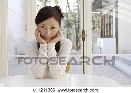 Stock Photograph - Portrait of a young woman smiling. Fotosearch
