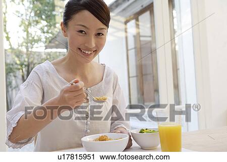View of a cheerful woman having breakfast View Large Photo Image Stock Image - View of a cheerful woman having breakfast. Fotosearch