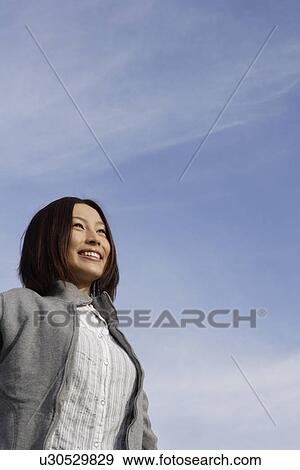 Stock Photo - View of a cheerful woman. Fotosearch