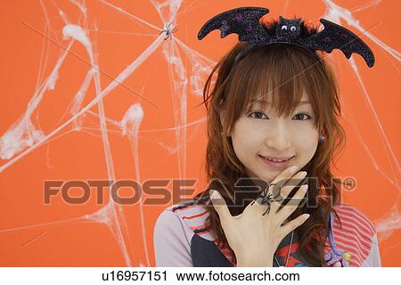 Stock Image - Close-up of teenage girl wearing a headdress. Fotosearch