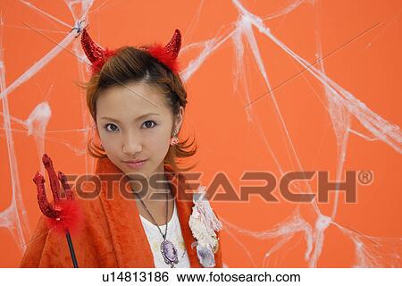 Stock Photograph - Close-up of teenage girl with a trident. Fotosearch