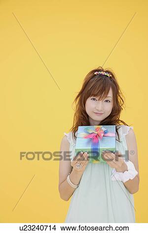 Portrait of a teenage girl with a gift box View Large Photo Image Picture - Portrait of a teenage girl with a gift box. Fotosearch