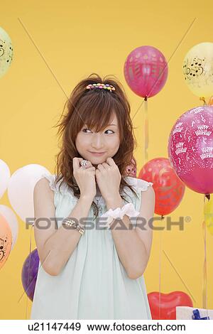 Stock Photo - Portrait of a teenage girl with hand on chin. Fotosearch