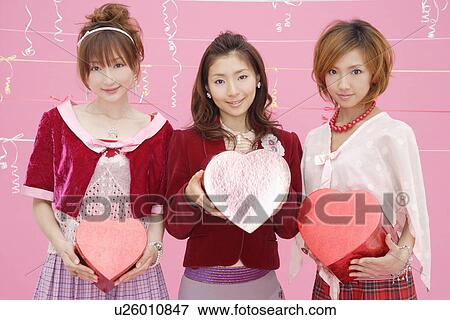 Portrait of teenage girls holding boxes View Large Photo Image Stock Photo - Portrait of teenage girls holding boxes. Fotosearch