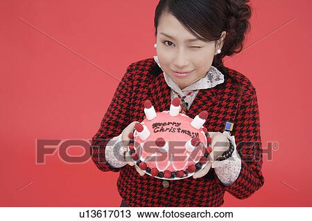 View of teenage girl holding a birthday cake View Large Photo Image Stock Image - View of teenage girl holding a birthday cake. Fotosearch