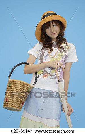Stock Photo - Portrait of a teenage girl holding a basket. Fotosearch