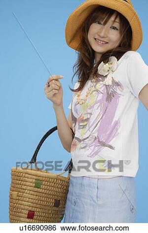 Stock Photograph - Portrait of a teenage girl holding a basket. Fotosearch