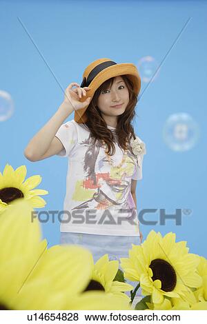 Stock Photo - Portrait of a teenage girl wearing a hat. Fotosearch