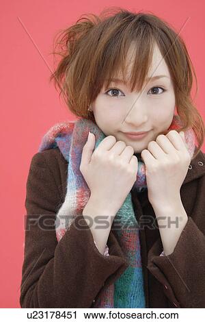 Stock Image - Portrait of a teenage girl wearing a muffler. Fotosearch