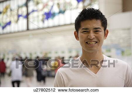 Stock Image - A young man smiling. Fotosearch