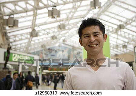 Stock Photo - A young man smiling. Fotosearch