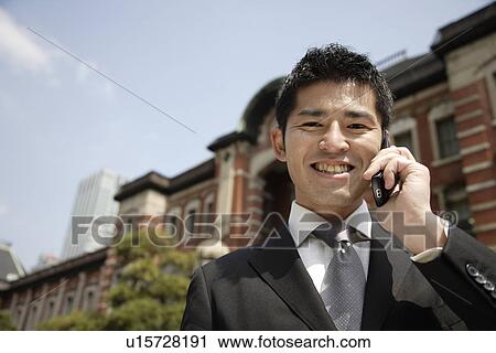 Close-up of a businessman using mobile phone View Large Photo Image Stock Image - Close-up of a businessman using mobile phone. Fotosearch