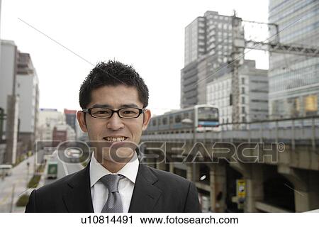 Stock Image - Close-up of a businessman wearing spectacles. Fotosearch
